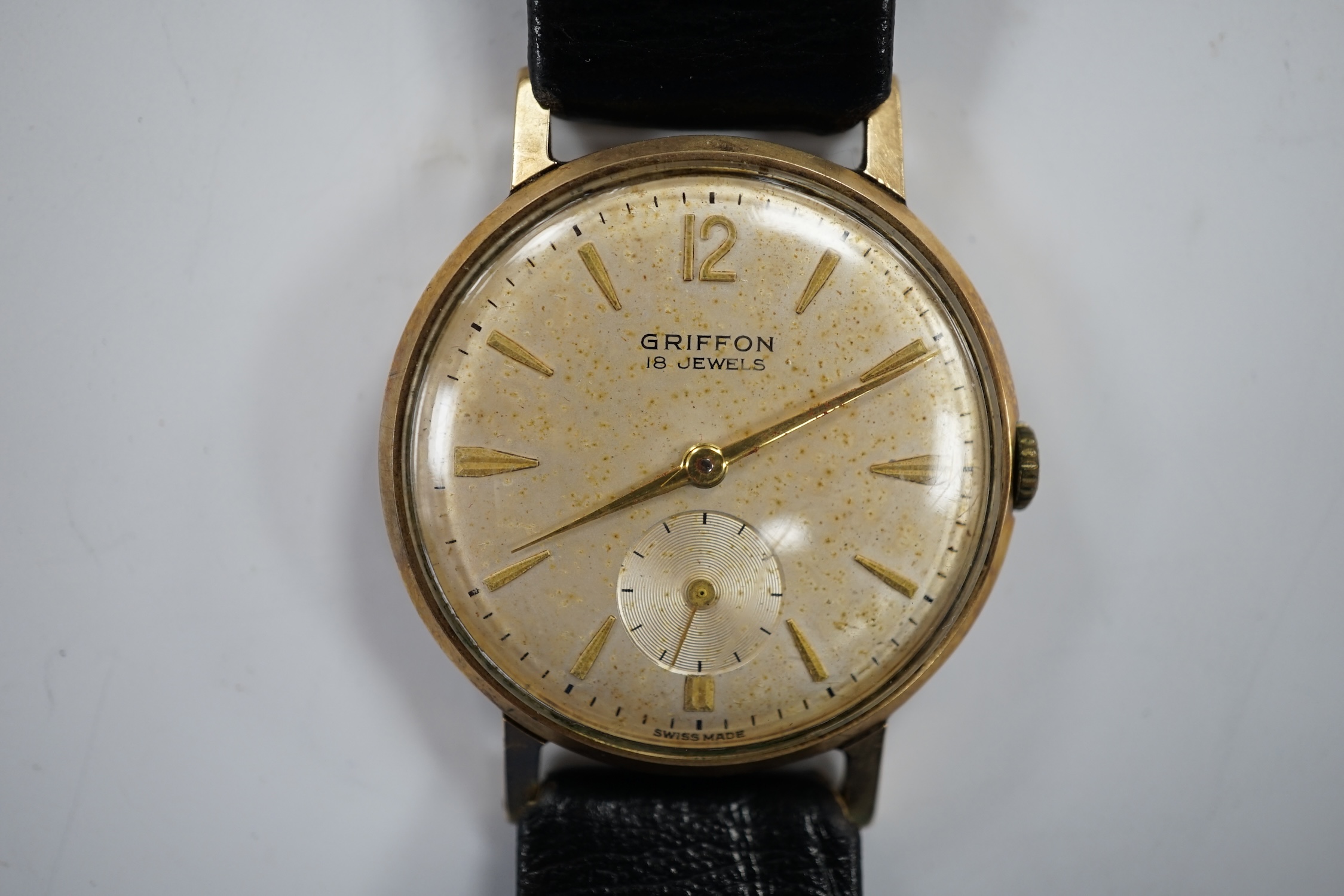 A gentleman's Swiss 9ct gold Griffon manual wind wrist watch, on a leather strap, case diameter 33mm.